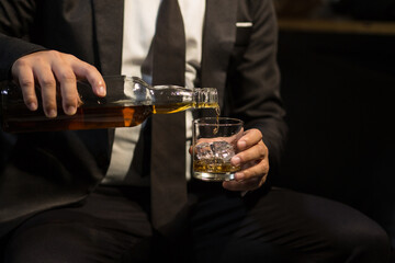 Businessmen in suits drinking whiskey