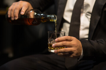 Businessmen in suits drinking whiskey