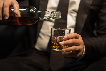 Businessmen in suits drinking whiskey