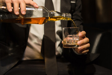 Businessmen in suits drinking whiskey