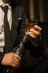 Businessmen in suits drinking whiskey