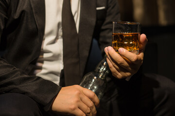 Businessmen in suits drinking whiskey