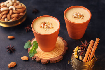Kesar Badam milk shake Almond Saffron milk  serving smoothie terracotta glass Kerala India. Kheer...