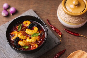 Serving Shrimp masala fish curry Chemmeen curry tiger Prawns balchao Curry. Spicy Kerala fish curry Indian seafood non veg food side dish rice appam Goan Tamil Nadu Bengal Sri Lankan