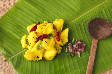 Cooked tapioca or Cassava root Mandioca Aipim Kappa Indian food serving on banana leaf. South...