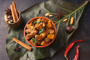  Traditional homemade Mutton curry from Asian cuisine Chukhandar gosht spicy meat beef curry served coconut shell mutton roast Indian spices. side dish Ghee rice Appam Parotta