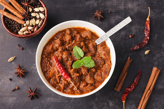 Traditional homemade Mutton curry from Asian cuisine Chukhandar gosht woman hand eating spicy meat beef curry coconut mutton roast Indian spices. side dish Ghee rice Appam Parotta