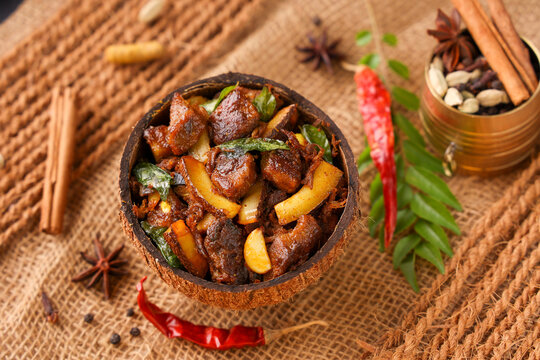  Traditional homemade Mutton curry from Asian cuisine Chukhandar gosht spicy meat beef curry coconut pieces mutton roast Indian spices. side dish Ghee rice Appam Parotta