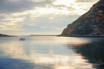 Morro Bay State park, California Coastline. Beautiful Morro Rock, quiet water, and cloudy sky