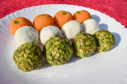 Tricolor Tiranga sweets Ladoo or Laddu for Indian Republic day and Independence day , served in ceramic plate. Close up of Indian flag three colours food celebration