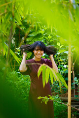 Forest garden in Indian woman purple dress relax style concept. 20s Asian female black short hair