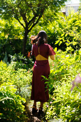 Forest garden in Indian woman purple dress relax style concept. 20s Asian female black short hair
