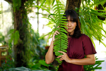 Forest garden in Indian woman purple dress relax style concept. 20s Asian female black short hair