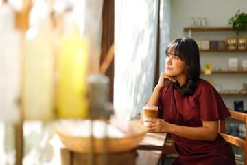Portrait of young Indian female in coffee shop with relax environment Tanned skin Asian woman purple