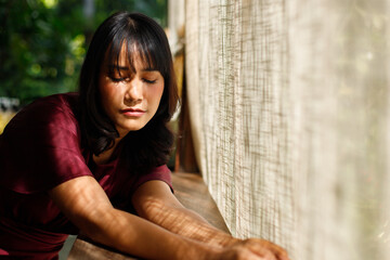 Portrait of young Indian female still sleepy and lay down table relax environment, Tanned skin Asian