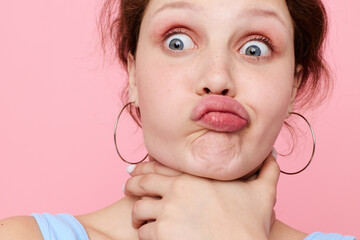 pretty woman blue t shirt hand gestures emotion pink background unaltered