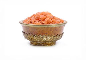 Pink Himalayan salt in Antique Tibetan bowl isolated on white background