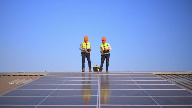 Engineer wearing unifrom and helmet inspect and check solar cell panel ,solar cell is ecology energy sunlight power installation for industrail ,alternative environment power concept.	

