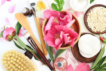 Botanical beauty treatment homemade cosmetic product, rolled oats, essential oil top view ingredients fresh pink peony rose petals, aromatherapy massage and herbal skincare spa product recipe.