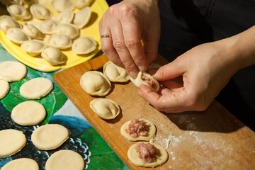 Cooking homemade meals. Modeling dumplings close-up.