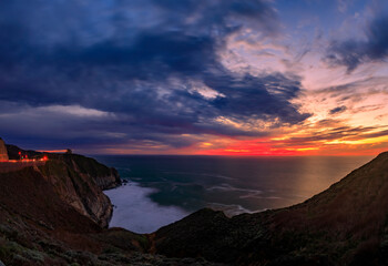 Coastal cliffs and silky ocean by Devil's Slide trail in California at sunset