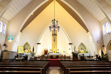 The interior of a church showing the pews the alter and the cross. Church for wedding holy matimony.