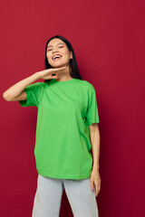 woman with Asian appearance green t-shirt gestures with his hands isolated background unaltered