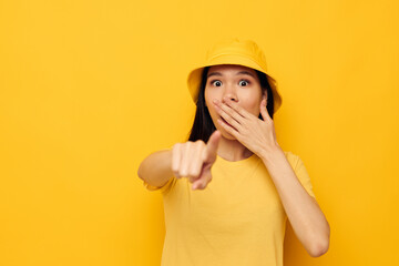 Portrait Asian beautiful young woman wearing a yellow hat posing emotions studio model unaltered