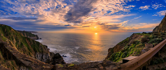 Coastal cliffs and silky ocean by Devil's Slide trail in California at sunset - Powered by Adobe