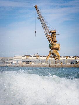  Yellow crane in cargo port translating coal. Industrial scene