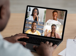 Fototapeta na wymiar Cropped of black man using laptop, having video chat