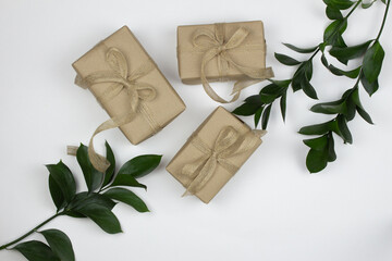 Gifts in craft paper on a light table. Flat lay zero waste, environmentally friendly packaging