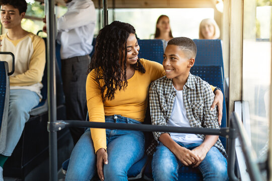 Beautiful smiling African American family going on a bus
