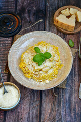  Italian  home made  creamy risotto milanese  with parmesan cheese and fresh basil on rustic background