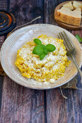  Italian  home made  creamy risotto milanese  with parmesan cheese and fresh basil on rustic background