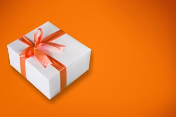 Beautiful giftbox with satin ribbon bow on the desk