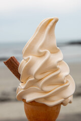 A soft serve Icecream with a chocolate flake taken on a summers day on a beach in Guernsey, Channel Islands
