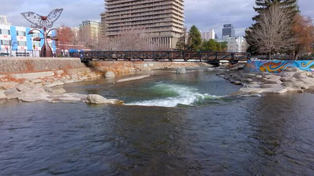 Push over rapids and towards and over pedestrian bridge on the Truckee River in downtown Reno, Nevada.