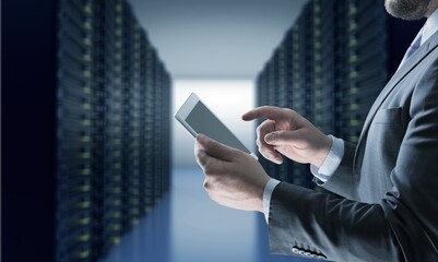 Portrait of Smiling IT Specialist Using Tablet Computer in Data Center room