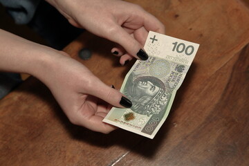 hand with money, banknotes of 100 Polsih zloty
