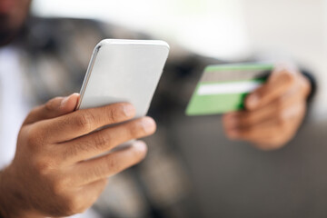 Cropped of man holding cellphone and credit card