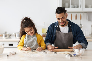 Positive Arab Family Dad And Daughter Baking Cookies In Kitchen Together