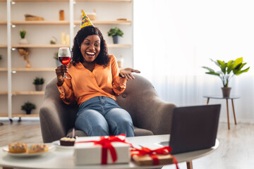 African Female Celebrating Birthday In Front Of Laptop At Home