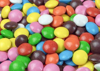 Fototapeta na wymiar Round milk chocolate balls of different colors