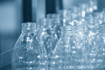 The empty PET bottles  on the conveyor belt for filling process in the drinking water factory.