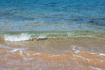 Tropical beach background. Sandy beach with calm wave of turquoise ocean. Maldives, perfect scenery landscape, copy space.