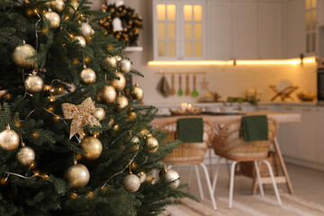 Beautiful Christmas tree in spacious kitchen, closeup. Space for text