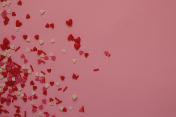 pink background with sprinkles hearts with space for text