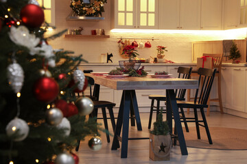 Cozy dining room interior with Christmas tree and beautiful festive decor