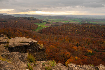 Magnificent panoramic view over an autumnal forest landscape, seen from the Hohenstein rock plateau, Süntel, Weser Uplands, Lower Saxony, Germany